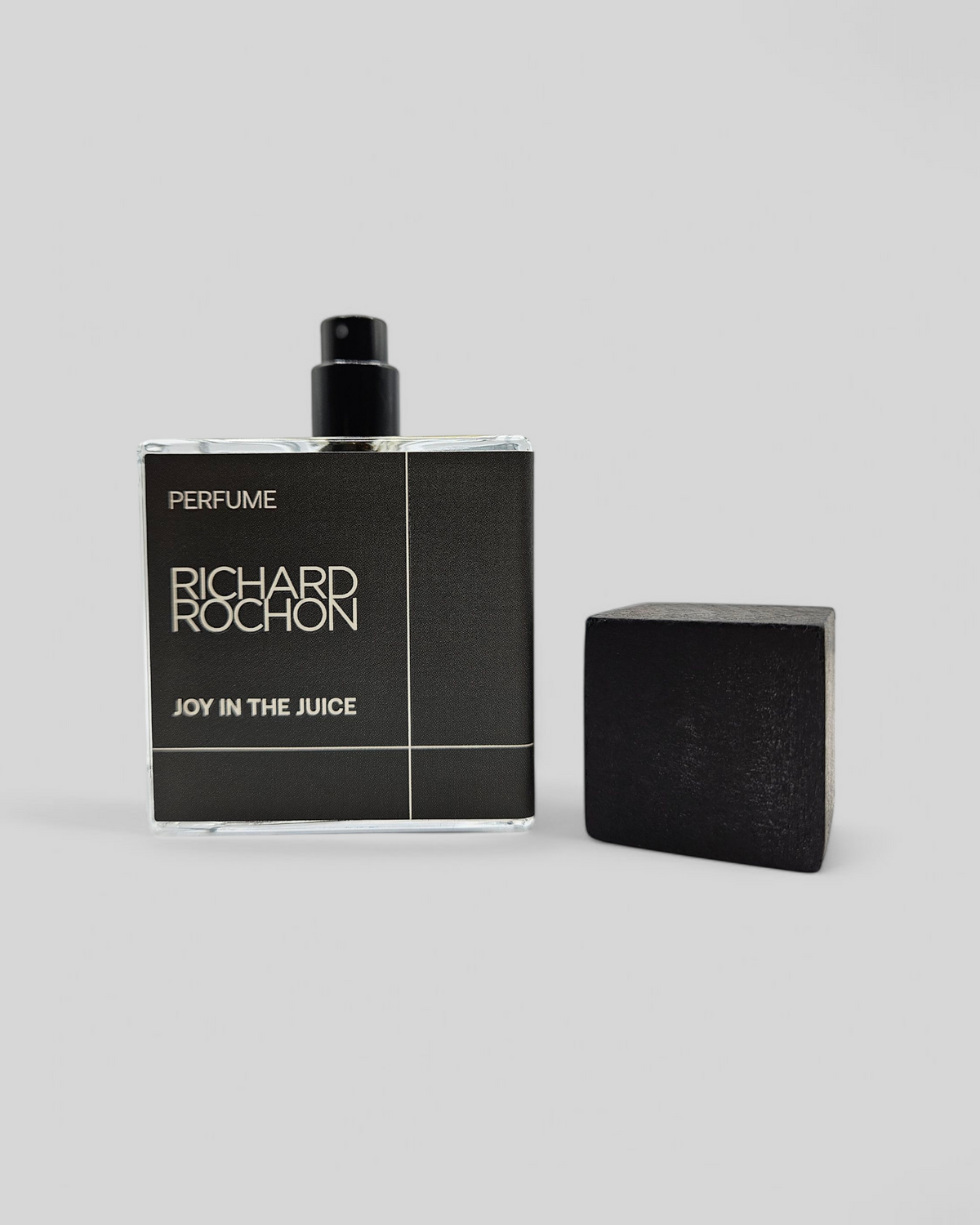 Joy in the Juice product photo – luxury niche fragrance with moss, salt air, and cold woods